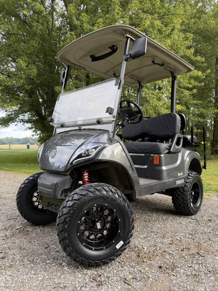Lifted carbon 2021 Yamaha Drive2 EFI golf cart with black wheels, sold by Rugged Buggies, Byron, MI