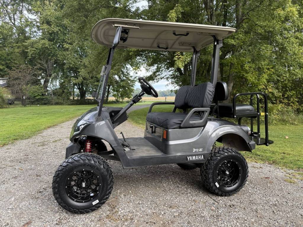 Lifted carbon 2021 Yamaha Drive2 EFI golf cart with black wheels, sold by Rugged Buggies, Byron, MI