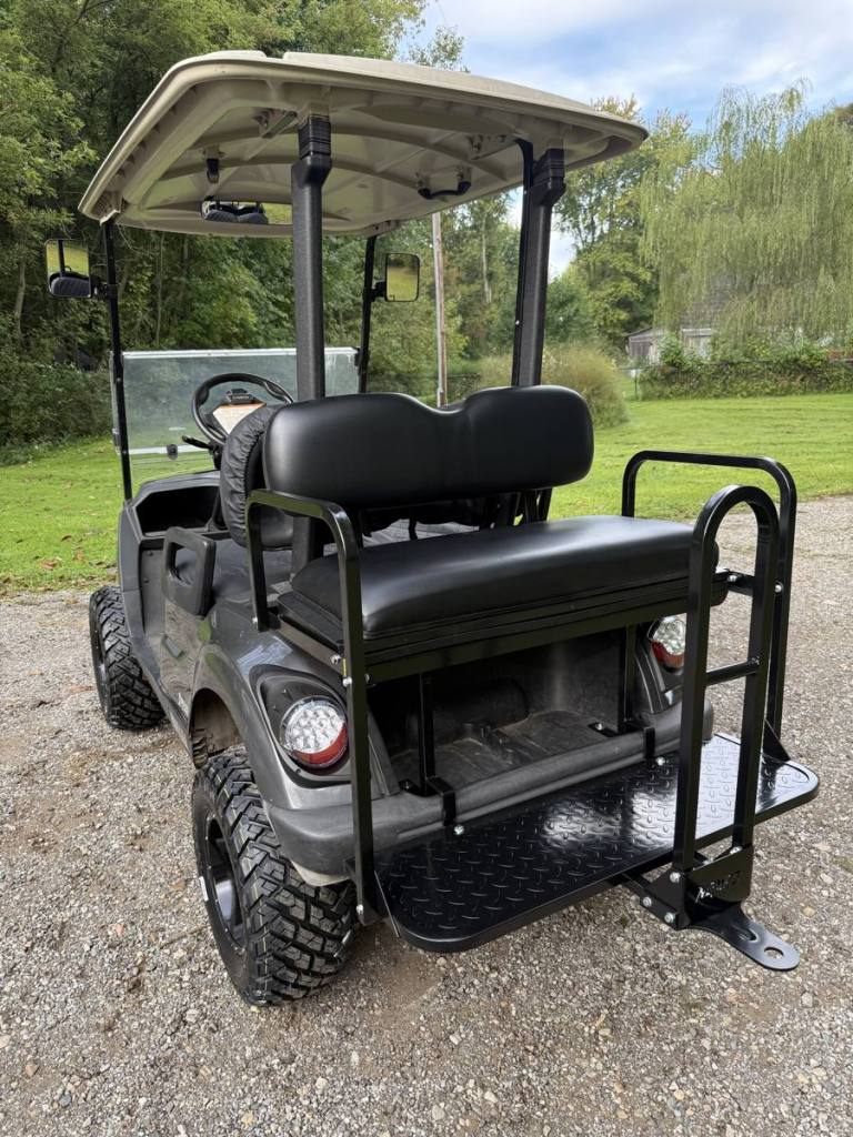 Lifted carbon 2021 Yamaha Drive2 EFI golf cart with black wheels, sold by Rugged Buggies, Byron, MI