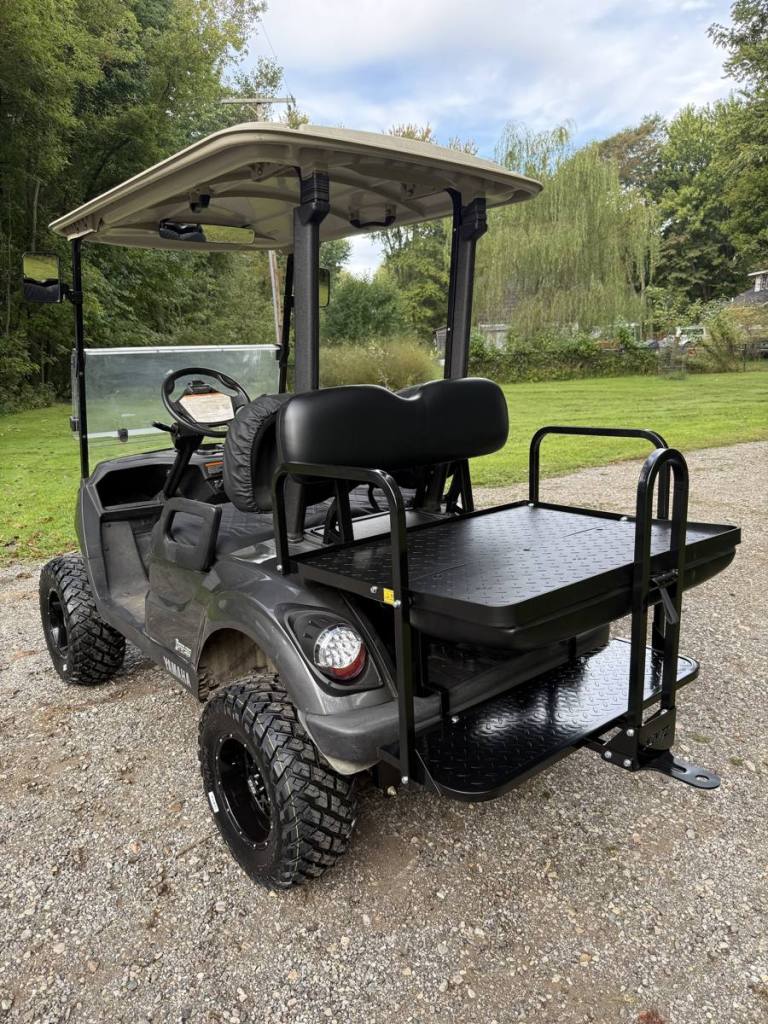 Lifted carbon 2021 Yamaha Drive2 EFI golf cart with black wheels, sold by Rugged Buggies, Byron, MI