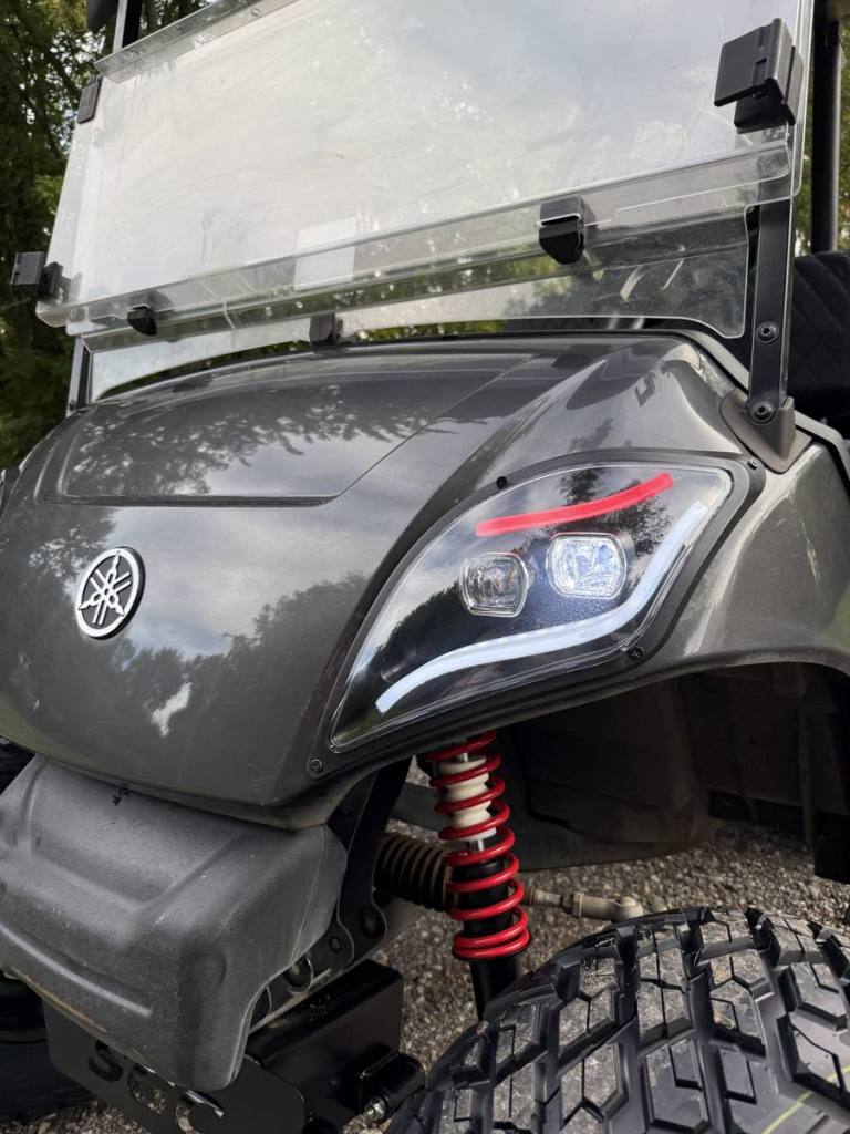 Lifted carbon 2021 Yamaha Drive2 EFI golf cart with black wheels, sold by Rugged Buggies, Byron, MI