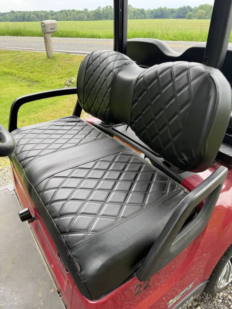 Black diamond-stitched golf cart seat cover on a red Yamaha